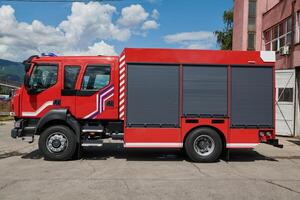 A state-of-the-art firetruck, equipped with advanced rescue technology, stands ready with its skilled firefighting team, prepared to intervene and respond rapidly to emergencies, ensuring the safety photo