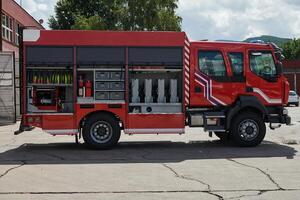 A state-of-the-art firetruck, equipped with advanced rescue technology, stands ready with its skilled firefighting team, prepared to intervene and respond rapidly to emergencies, ensuring the safety photo