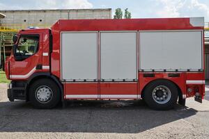 A state-of-the-art firetruck, equipped with advanced rescue technology, stands ready with its skilled firefighting team, prepared to intervene and respond rapidly to emergencies, ensuring the safety photo
