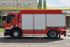 A state-of-the-art firetruck, equipped with advanced rescue technology, stands ready with its skilled firefighting team, prepared to intervene and respond rapidly to emergencies, ensuring the safety photo