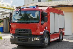 A state-of-the-art firetruck, equipped with advanced rescue technology, stands ready with its skilled firefighting team, prepared to intervene and respond rapidly to emergencies, ensuring the safety photo