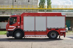 A state-of-the-art firetruck, equipped with advanced rescue technology, stands ready with its skilled firefighting team, prepared to intervene and respond rapidly to emergencies, ensuring the safety photo