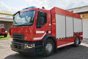 A state-of-the-art firetruck, equipped with advanced rescue technology, stands ready with its skilled firefighting team, prepared to intervene and respond rapidly to emergencies, ensuring the safety photo
