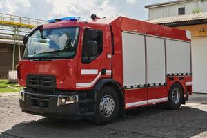 A state-of-the-art firetruck, equipped with advanced rescue technology, stands ready with its skilled firefighting team, prepared to intervene and respond rapidly to emergencies, ensuring the safety photo