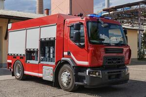 A state-of-the-art firetruck, equipped with advanced rescue technology, stands ready with its skilled firefighting team, prepared to intervene and respond rapidly to emergencies, ensuring the safety photo