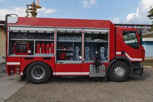 A state-of-the-art firetruck, equipped with advanced rescue technology, stands ready with its skilled firefighting team, prepared to intervene and respond rapidly to emergencies, ensuring the safety photo