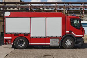 A state-of-the-art firetruck, equipped with advanced rescue technology, stands ready with its skilled firefighting team, prepared to intervene and respond rapidly to emergencies, ensuring the safety photo