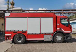 A state-of-the-art firetruck, equipped with advanced rescue technology, stands ready with its skilled firefighting team, prepared to intervene and respond rapidly to emergencies, ensuring the safety photo