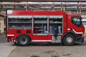 A state-of-the-art firetruck, equipped with advanced rescue technology, stands ready with its skilled firefighting team, prepared to intervene and respond rapidly to emergencies, ensuring the safety photo