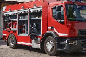 A state-of-the-art firetruck, equipped with advanced rescue technology, stands ready with its skilled firefighting team, prepared to intervene and respond rapidly to emergencies, ensuring the safety photo