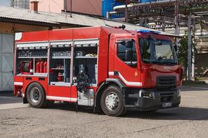 A state-of-the-art firetruck, equipped with advanced rescue technology, stands ready with its skilled firefighting team, prepared to intervene and respond rapidly to emergencies, ensuring the safety photo