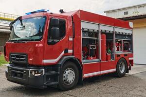 A state-of-the-art firetruck, equipped with advanced rescue technology, stands ready with its skilled firefighting team, prepared to intervene and respond rapidly to emergencies, ensuring the safety photo