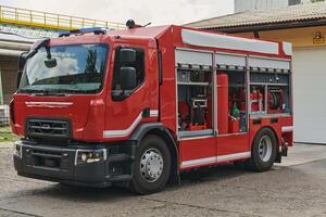 A state-of-the-art firetruck, equipped with advanced rescue technology, stands ready with its skilled firefighting team, prepared to intervene and respond rapidly to emergencies, ensuring the safety photo