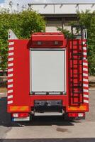 A state-of-the-art firetruck, equipped with advanced rescue technology, stands ready with its skilled firefighting team, prepared to intervene and respond rapidly to emergencies, ensuring the safety photo