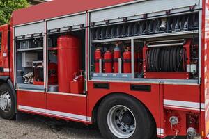 A state-of-the-art firetruck, equipped with advanced rescue technology, stands ready with its skilled firefighting team, prepared to intervene and respond rapidly to emergencies, ensuring the safety photo