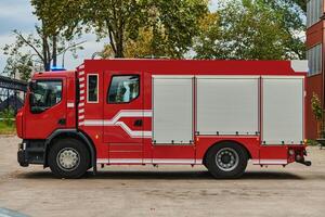 A state-of-the-art firetruck, equipped with advanced rescue technology, stands ready with its skilled firefighting team, prepared to intervene and respond rapidly to emergencies, ensuring the safety photo