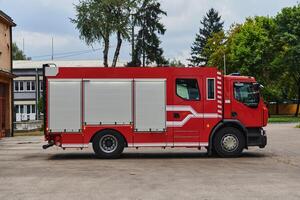 A state-of-the-art firetruck, equipped with advanced rescue technology, stands ready with its skilled firefighting team, prepared to intervene and respond rapidly to emergencies, ensuring the safety photo