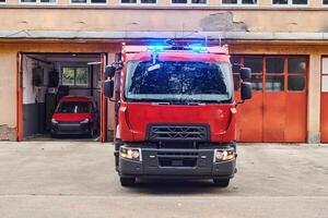 A state-of-the-art firetruck, equipped with advanced rescue technology, stands ready with its skilled firefighting team, prepared to intervene and respond rapidly to emergencies, ensuring the safety photo