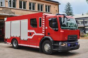 A state-of-the-art firetruck, equipped with advanced rescue technology, stands ready with its skilled firefighting team, prepared to intervene and respond rapidly to emergencies, ensuring the safety photo