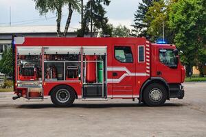 A state-of-the-art firetruck, equipped with advanced rescue technology, stands ready with its skilled firefighting team, prepared to intervene and respond rapidly to emergencies, ensuring the safety photo