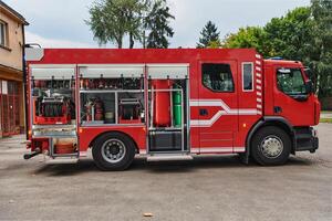 A state-of-the-art firetruck, equipped with advanced rescue technology, stands ready with its skilled firefighting team, prepared to intervene and respond rapidly to emergencies, ensuring the safety photo