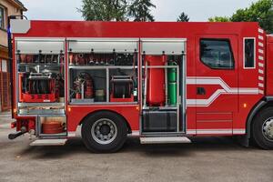 A state-of-the-art firetruck, equipped with advanced rescue technology, stands ready with its skilled firefighting team, prepared to intervene and respond rapidly to emergencies, ensuring the safety photo