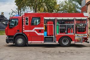 A state-of-the-art firetruck, equipped with advanced rescue technology, stands ready with its skilled firefighting team, prepared to intervene and respond rapidly to emergencies, ensuring the safety photo