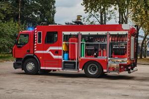 A state-of-the-art firetruck, equipped with advanced rescue technology, stands ready with its skilled firefighting team, prepared to intervene and respond rapidly to emergencies, ensuring the safety photo