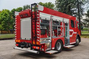 A state-of-the-art firetruck, equipped with advanced rescue technology, stands ready with its skilled firefighting team, prepared to intervene and respond rapidly to emergencies, ensuring the safety photo