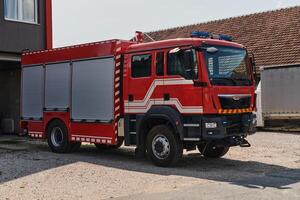 A state-of-the-art firetruck, equipped with advanced rescue technology, stands ready with its skilled firefighting team, prepared to intervene and respond rapidly to emergencies, ensuring the safety photo