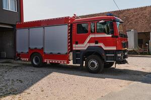 A state-of-the-art firetruck, equipped with advanced rescue technology, stands ready with its skilled firefighting team, prepared to intervene and respond rapidly to emergencies, ensuring the safety photo