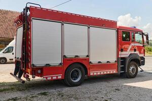 A state-of-the-art firetruck, equipped with advanced rescue technology, stands ready with its skilled firefighting team, prepared to intervene and respond rapidly to emergencies, ensuring the safety photo