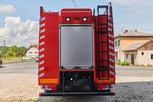 A state-of-the-art firetruck, equipped with advanced rescue technology, stands ready with its skilled firefighting team, prepared to intervene and respond rapidly to emergencies, ensuring the safety photo