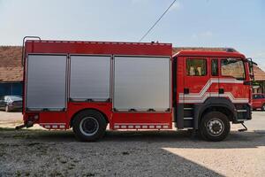 A state-of-the-art firetruck, equipped with advanced rescue technology, stands ready with its skilled firefighting team, prepared to intervene and respond rapidly to emergencies, ensuring the safety photo