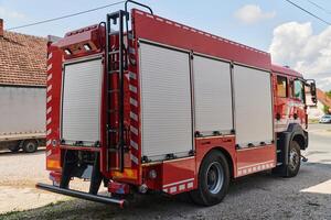 A state-of-the-art firetruck, equipped with advanced rescue technology, stands ready with its skilled firefighting team, prepared to intervene and respond rapidly to emergencies, ensuring the safety photo