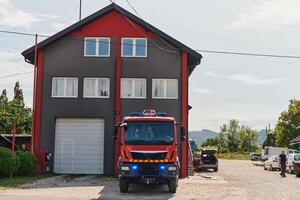 A state-of-the-art firetruck, equipped with advanced rescue technology, stands ready with its skilled firefighting team, prepared to intervene and respond rapidly to emergencies, ensuring the safety photo