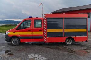 A state-of-the-art firetruck, equipped with advanced rescue technology, stands ready with its skilled firefighting team, prepared to intervene and respond rapidly to emergencies, ensuring the safety photo