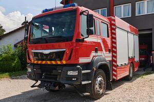 A state-of-the-art firetruck, equipped with advanced rescue technology, stands ready with its skilled firefighting team, prepared to intervene and respond rapidly to emergencies, ensuring the safety photo