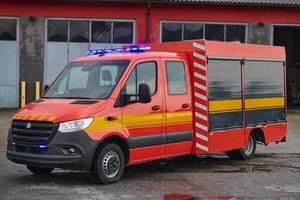 A state-of-the-art firetruck, equipped with advanced rescue technology, stands ready with its skilled firefighting team, prepared to intervene and respond rapidly to emergencies, ensuring the safety photo