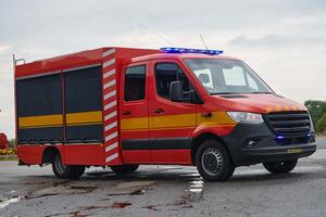 A state-of-the-art firetruck, equipped with advanced rescue technology, stands ready with its skilled firefighting team, prepared to intervene and respond rapidly to emergencies, ensuring the safety photo