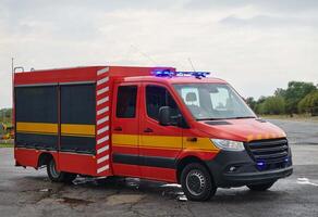 A state-of-the-art firetruck, equipped with advanced rescue technology, stands ready with its skilled firefighting team, prepared to intervene and respond rapidly to emergencies, ensuring the safety photo