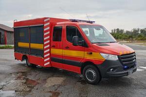 A state-of-the-art firetruck, equipped with advanced rescue technology, stands ready with its skilled firefighting team, prepared to intervene and respond rapidly to emergencies, ensuring the safety photo