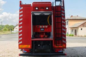 A state-of-the-art firetruck, equipped with advanced rescue technology, stands ready with its skilled firefighting team, prepared to intervene and respond rapidly to emergencies, ensuring the safety photo