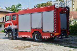 A state-of-the-art firetruck, equipped with advanced rescue technology, stands ready with its skilled firefighting team, prepared to intervene and respond rapidly to emergencies, ensuring the safety photo