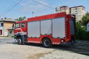A state-of-the-art firetruck, equipped with advanced rescue technology, stands ready with its skilled firefighting team, prepared to intervene and respond rapidly to emergencies, ensuring the safety photo