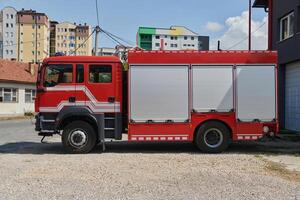 A state-of-the-art firetruck, equipped with advanced rescue technology, stands ready with its skilled firefighting team, prepared to intervene and respond rapidly to emergencies, ensuring the safety photo