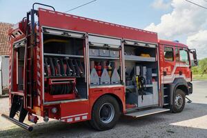 A state-of-the-art firetruck, equipped with advanced rescue technology, stands ready with its skilled firefighting team, prepared to intervene and respond rapidly to emergencies, ensuring the safety photo