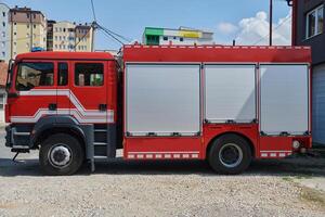 A state-of-the-art firetruck, equipped with advanced rescue technology, stands ready with its skilled firefighting team, prepared to intervene and respond rapidly to emergencies, ensuring the safety photo