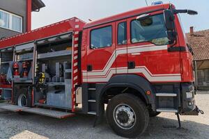 A state-of-the-art firetruck, equipped with advanced rescue technology, stands ready with its skilled firefighting team, prepared to intervene and respond rapidly to emergencies, ensuring the safety photo