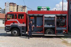 A dedicated firefighter preparing a modern firetruck for deployment to hazardous fire-stricken areas, demonstrating readiness and commitment to emergency response photo